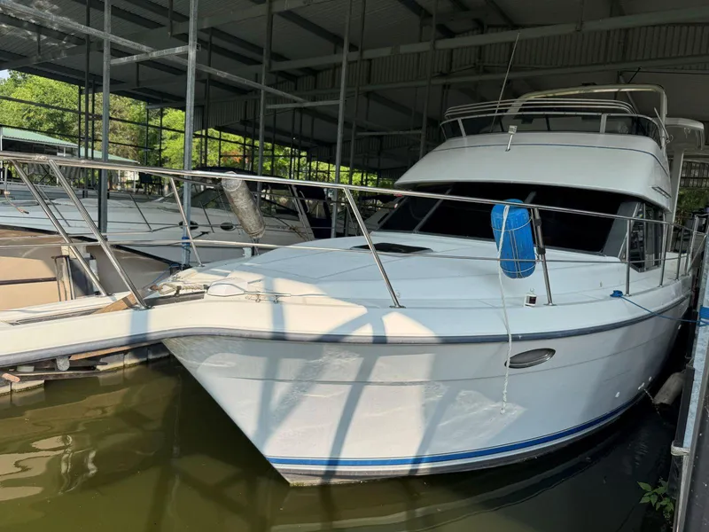 Slide: The Image of 1994 Carver 350 Aft Cabin yacht docked in a covered marina. - 5