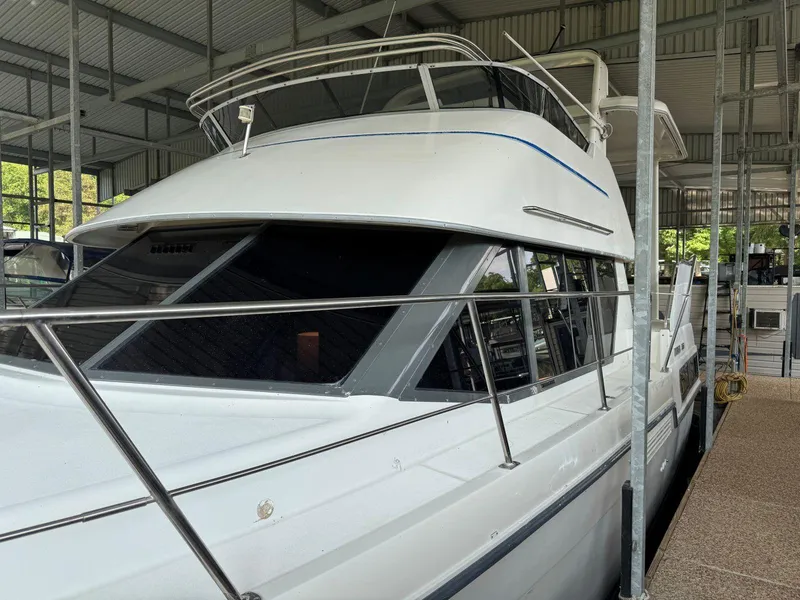 Slide: The Image of 1994 Carver 350 Aft Cabin yacht docked in a covered marina. - 6