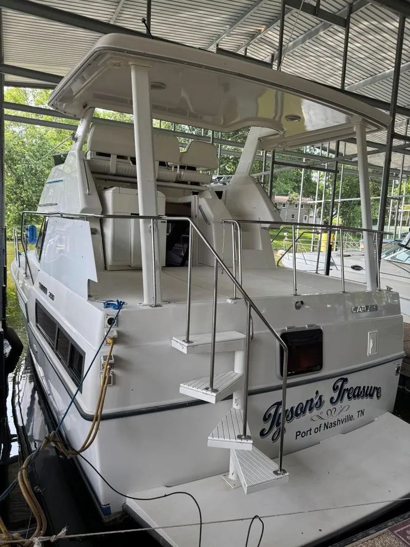 Slide: The Image of 1994 Carver 350 Aft Cabin yacht docked, featuring spacious aft deck and sleek design. - 7