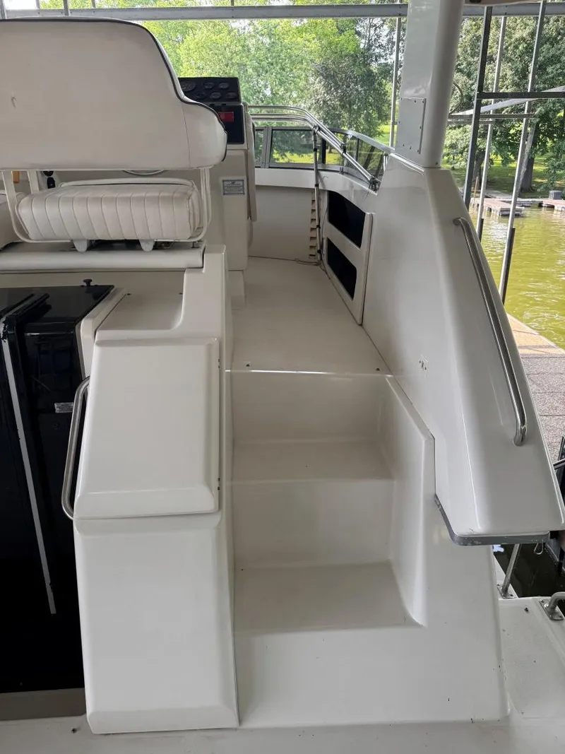 Slide: The Image of 1994 Carver 350 Aft Cabin boat interior with white seating and steps. - 9