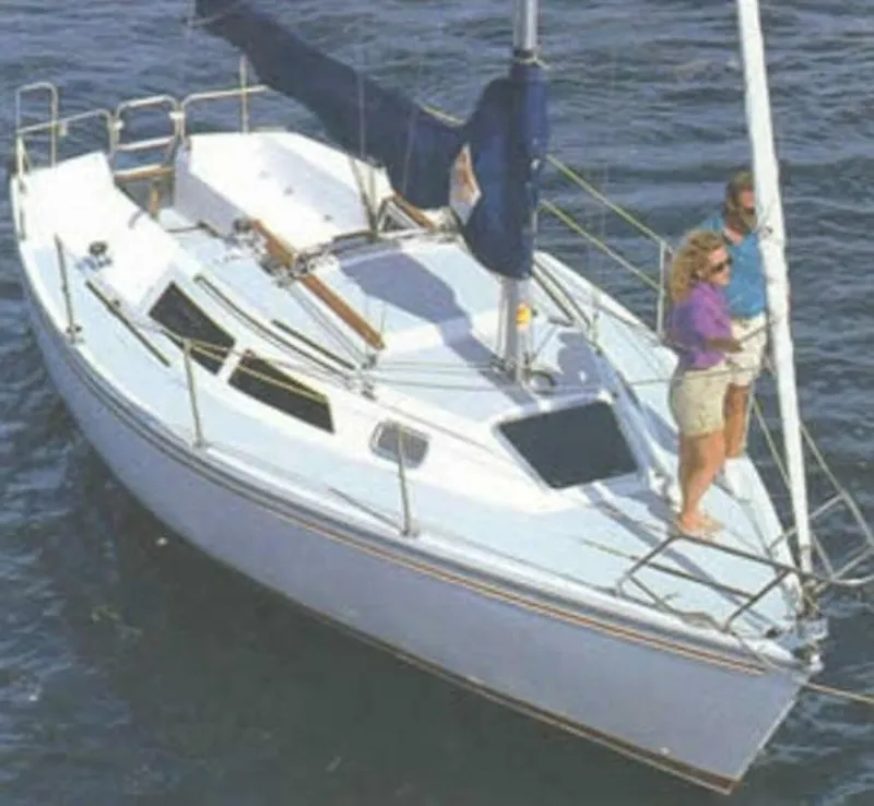 Slide: The Image of Catalina Capri 26 Wing Keel sailboat from 1990 on the water with two people onboard. - 10