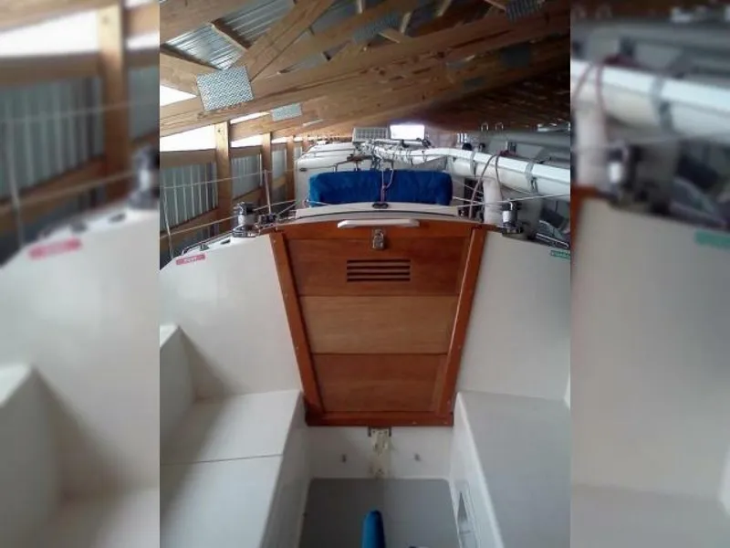 Slide: The Image of 1990 Catalina Capri 26 Wing Keel sailboat stored in a wooden boathouse. - 5