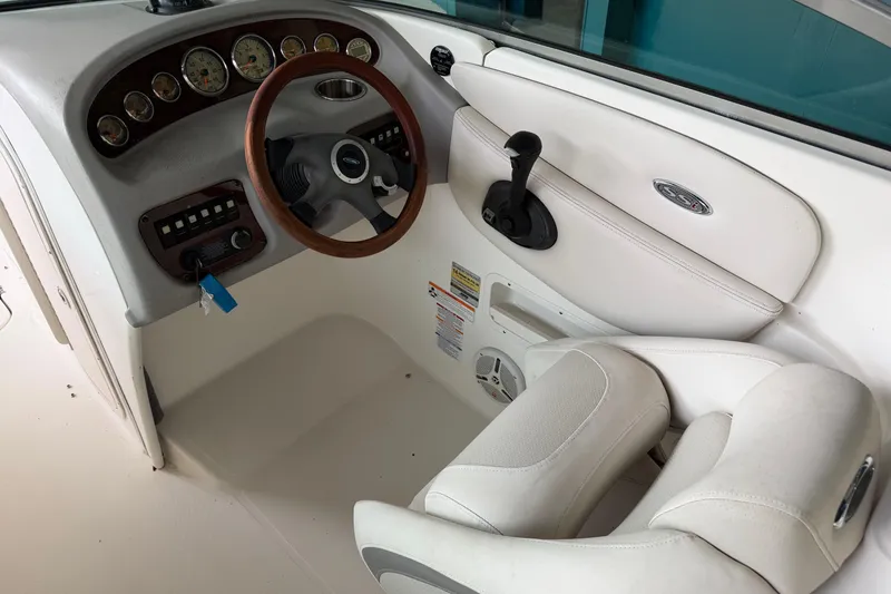 Slide: The Image of 2006 Chaparral 260 SSi boat cockpit with steering wheel and control panel. - 10