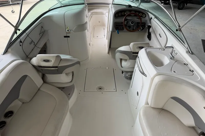 Slide: The Image of 2006 Chaparral 260 SSi boat interior with seating, steering wheel, and sink. - 11