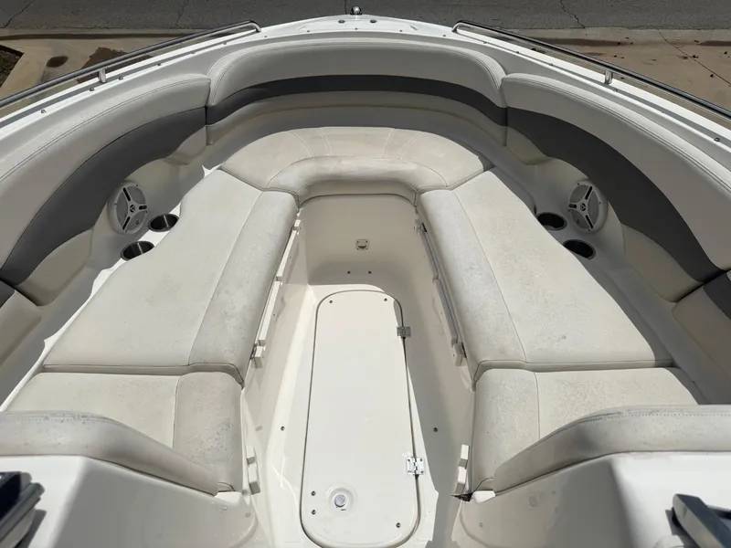 Slide: The Image of 2006 Chaparral 260 SSi boat interior with white cushioned seating and storage compartment. - 5