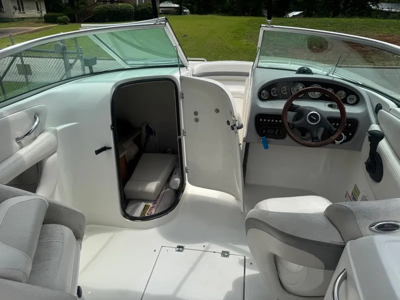 Slide: The Image of 2006 Chaparral 260 SSi boat interior with open cabin door and steering wheel. - 7