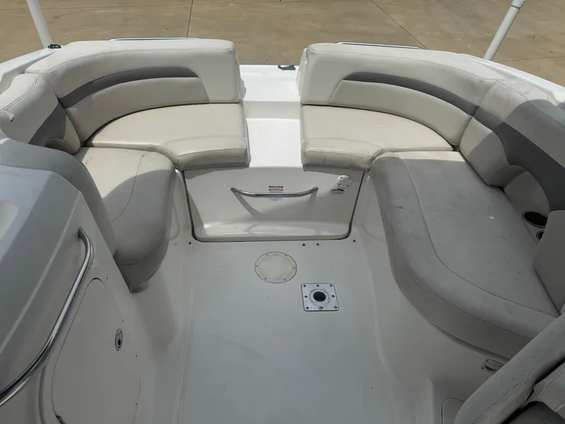 Slide: The Image of 2006 Chaparral 260 SSi boat interior with spacious seating and white upholstery. - 8