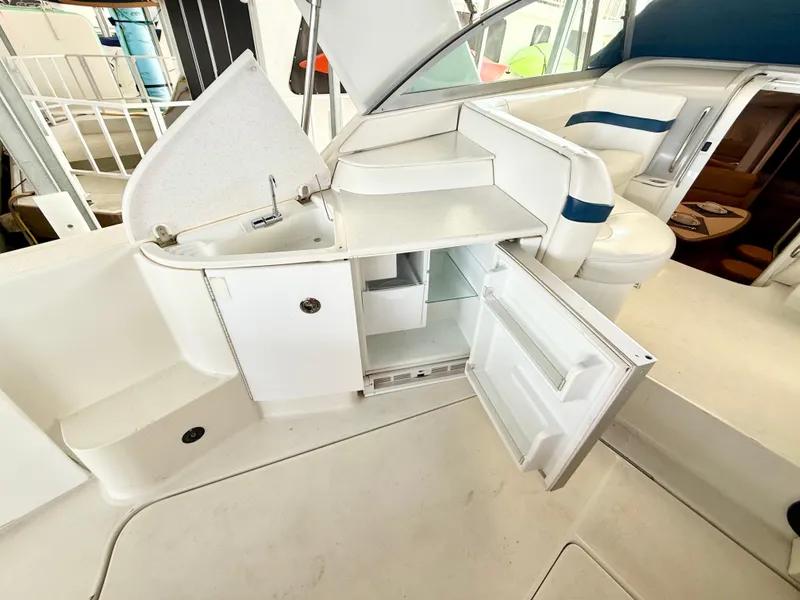 Slide: The Image of 1999 Formula 41 PC yacht interior with open mini fridge and sink area. - 12