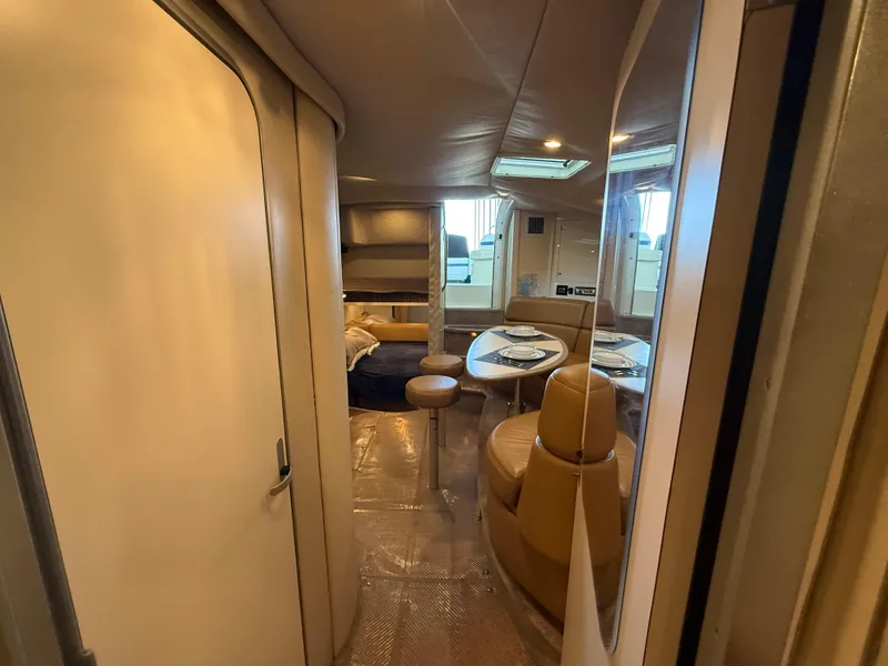 Slide: The Image of 1999 Formula 41 PC yacht interior with dining area and seating. - 23