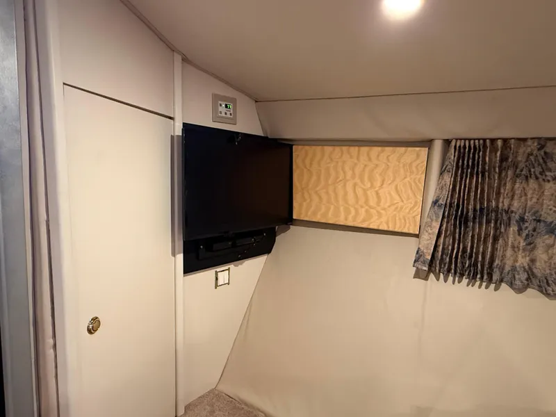 Slide: The Image of Interior of 1999 Formula 41 PC boat with TV, curtain, and storage. - 28
