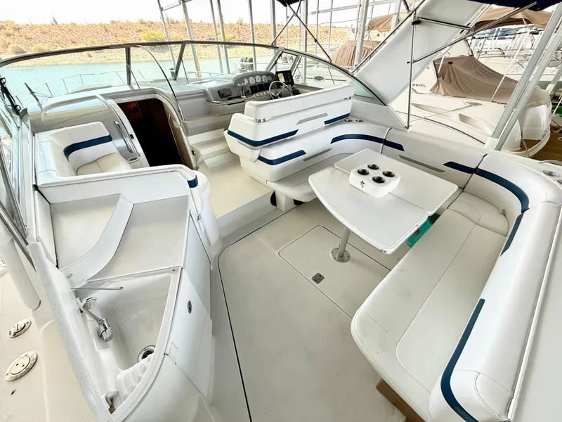 Slide: The Image of 1999 Formula 41 PC boat interior with white seating and helm, docked in marina. - 3
