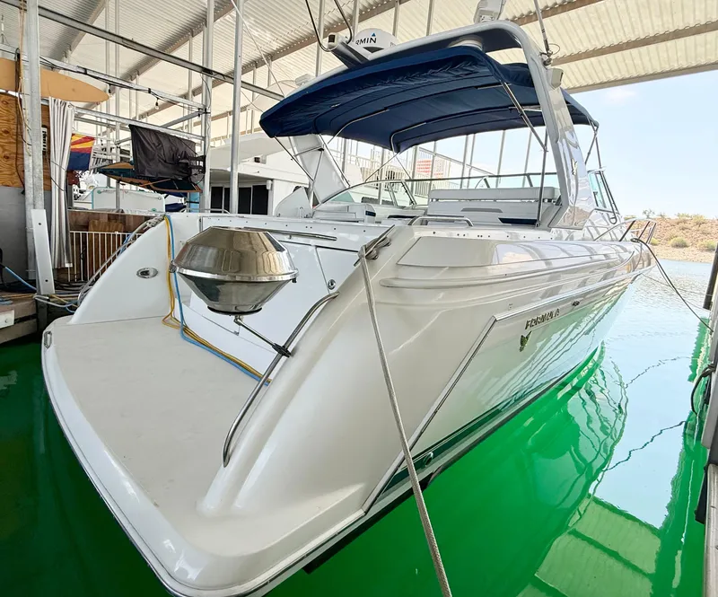 Slide: The Image of 1999 Formula 41 PC yacht docked in marina with blue canopy and stainless steel grill. - 34