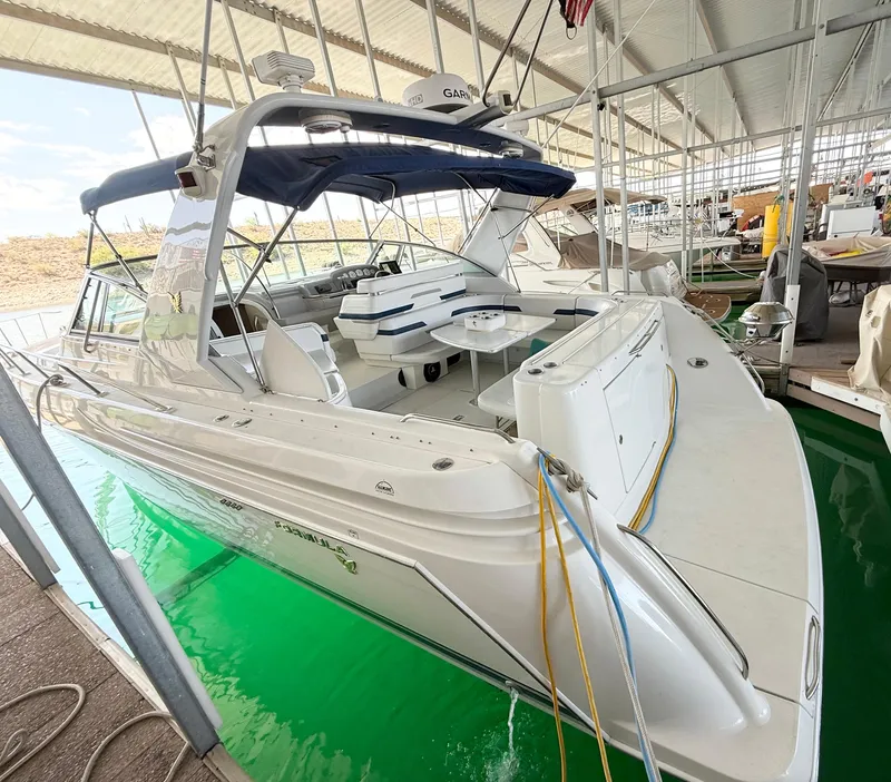 Slide: The Image of 1999 Formula 41 PC yacht docked in a covered marina, featuring spacious seating and sleek design. - 35