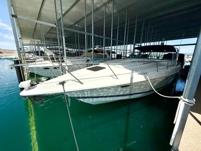 Slide: The Image of 1999 Formula 41 PC yacht docked in marina under metal canopy. - 37