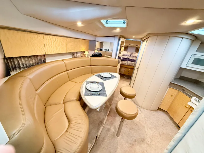 Slide: The Image of 1999 Formula 41 PC yacht interior with leather seating, dining area, and modern amenities. - 4