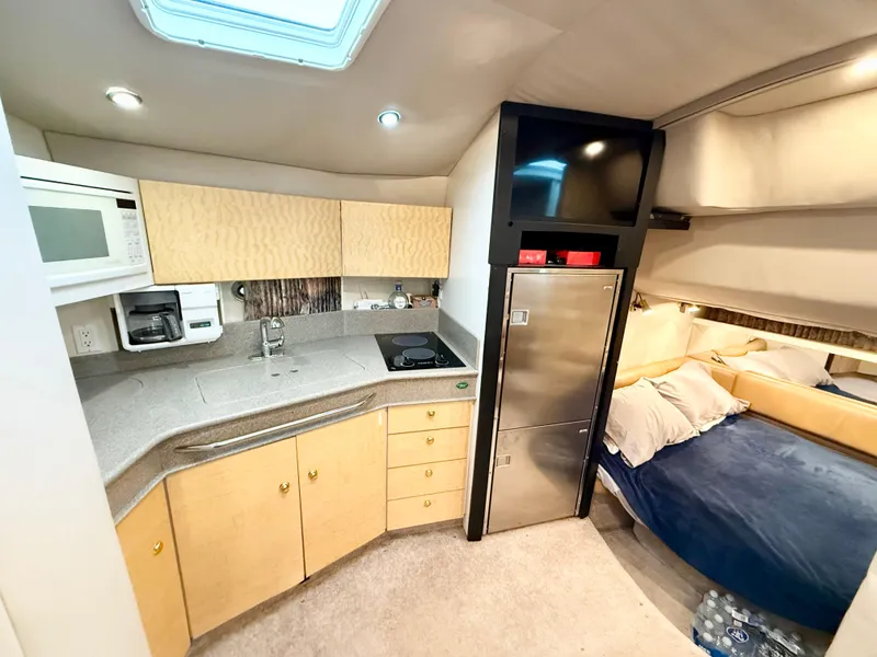 Slide: The Image of 1999 Formula 41 PC yacht interior with kitchenette, bed, and modern amenities. - 5