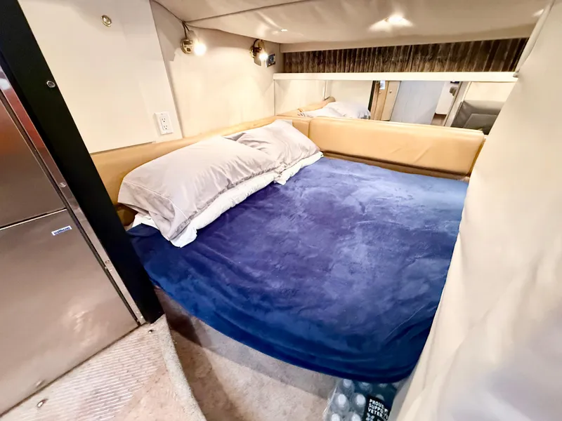 Slide: The Image of 1999 Formula 41 PC cabin with cozy bed, blue blanket, and ambient lighting. - 8