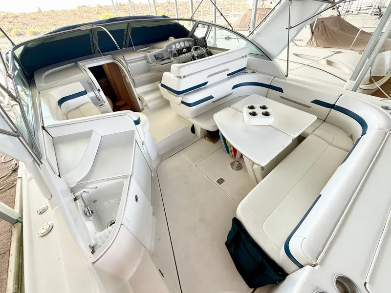 Slide: The Image of 1999 Formula 41 PC boat interior with white seating and a central table. - 9