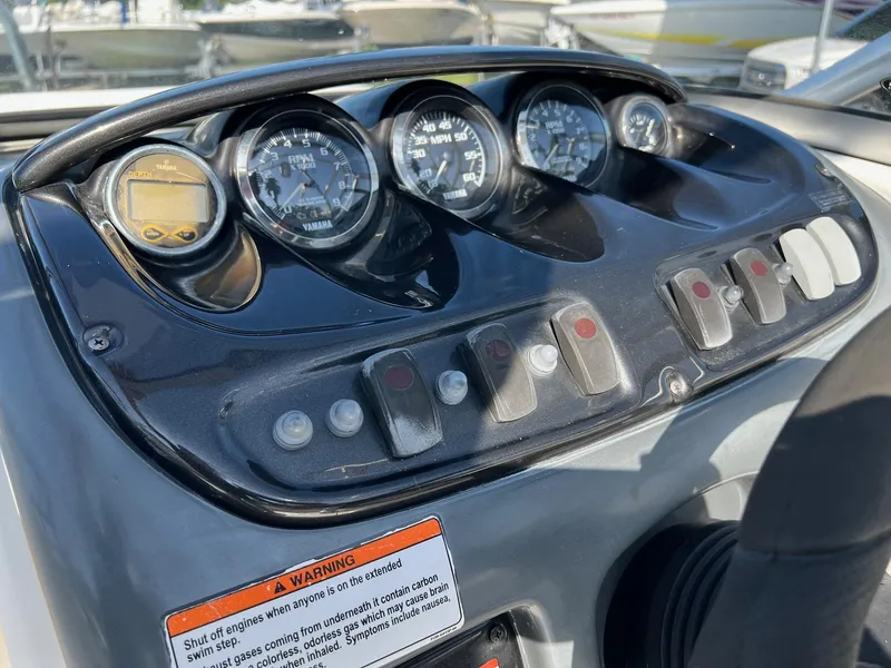 Slide: The Image of Dashboard of a 2006 Yamaha Boats SX210 with gauges and control switches. - 10