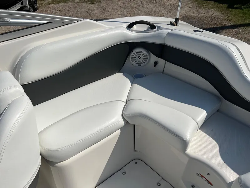 Slide: The Image of 2006 Yamaha SX210 boat interior with white seating and speaker. - 12