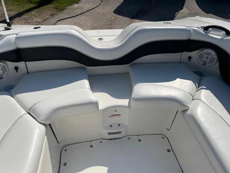 Slide: The Image of 2006 Yamaha SX210 boat interior with white cushioned seating. - 16