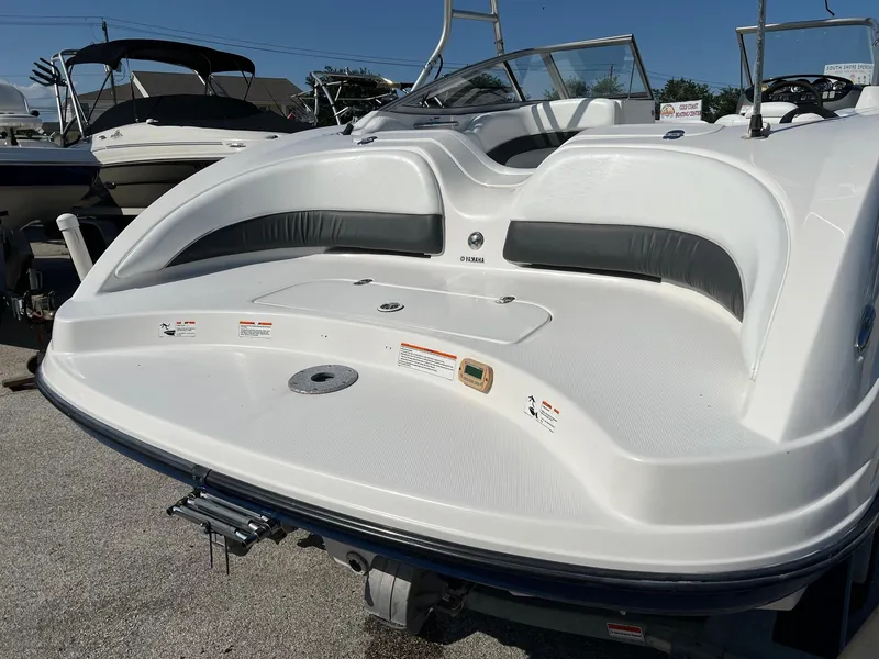 Slide: The Image of 2006 Yamaha Boats SX210, white deck, parked in marina, sunny day. - 18