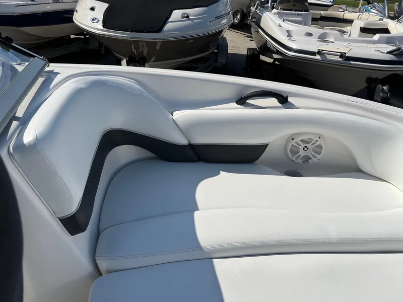 Slide: The Image of 2006 Yamaha SX210 boat interior with white seating and speaker detail. - 2