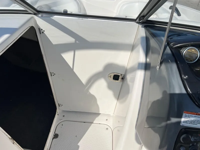 Slide: The Image of 2006 Yamaha SX210 boat interior, showing cockpit area with open storage compartment. - 7
