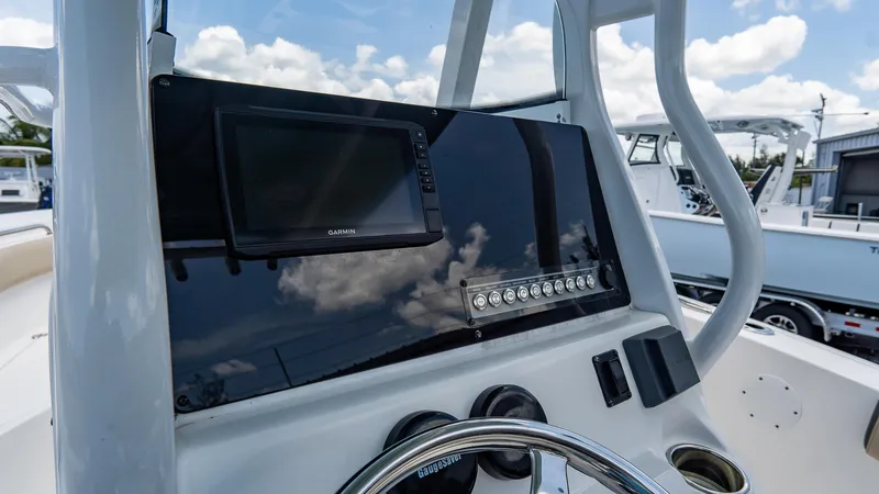 Slide: The Image of 2020 Tidewater 232 LXF boat dashboard with Garmin display and steering wheel. - 11