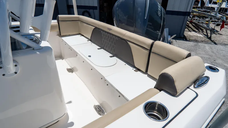 Slide: The Image of 2020 Tidewater 232 LXF boat interior with cushioned seating and cup holders. - 6