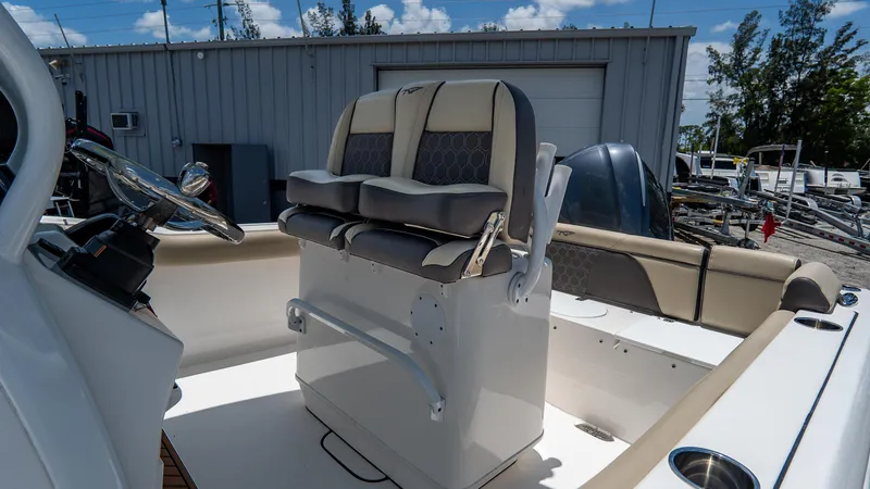 Slide: The Image of 2020 Tidewater 232 LXF boat interior with dual captain's chairs and steering wheel. - 9