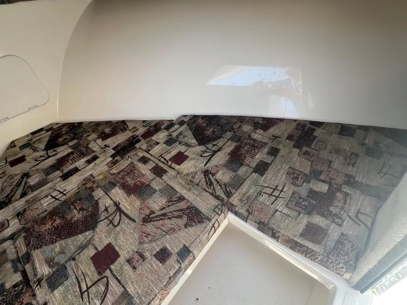 Slide: The Image of 2003 Shamrock 220 Cuddy cabin interior with patterned cushions. - 18