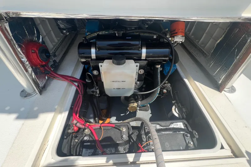 Slide: The Image of Engine compartment of 2003 Shamrock 220 Cuddy boat, showing detailed components and wiring. - 19