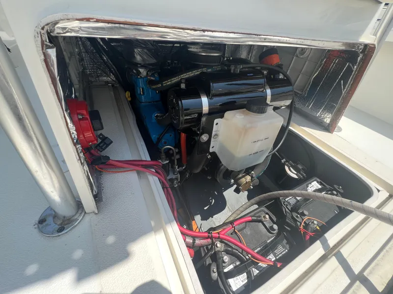 Slide: The Image of Engine compartment of a 2003 Shamrock 220 Cuddy boat, showing wiring and components. - 20