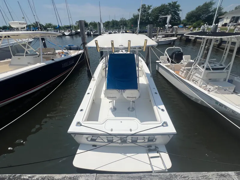 Slide: The Image of 2003 Shamrock 220 Cuddy boat docked at marina, surrounded by other vessels. - 3