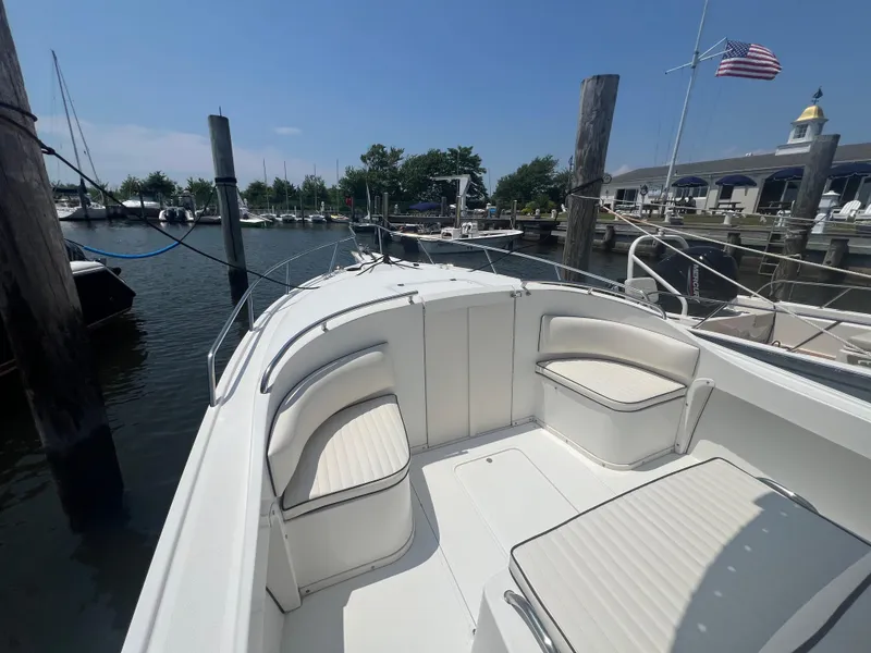 Slide: The Image of 2003 Shamrock 220 Cuddy boat docked at marina with American flag. - 6