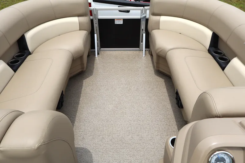 Slide: The Image of 2021 Starcraft LX 22 R boat interior with beige seating and cup holders. - 10