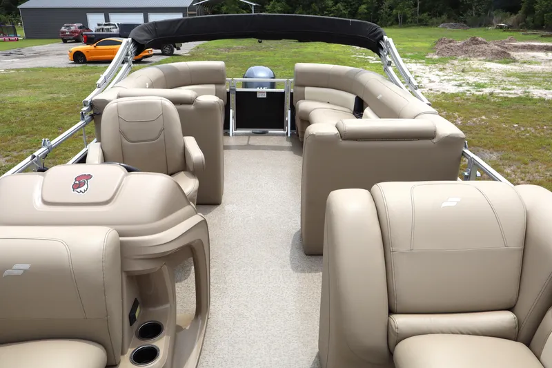 Slide: The Image of 2021 Starcraft LX 22 R pontoon boat with beige seating and spacious interior. - 11