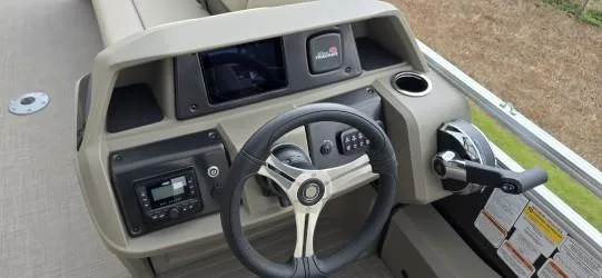 Slide: The Image of 2025 Sun Tracker SportFish 22 DLX dashboard with steering wheel and control panel. - 6