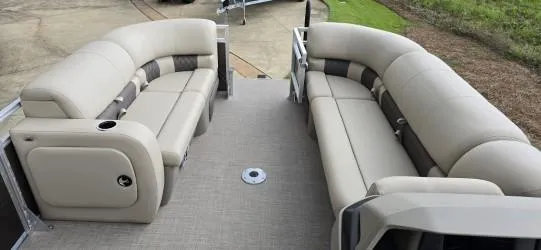 Slide: The Image of 2025 Sun Tracker SportFish 22 DLX pontoon boat with beige seating and spacious deck. - 7