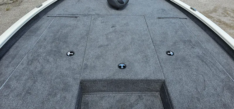 Slide: The Image of 2025 Tracker Savage 215 boat deck with gray carpeting and storage compartments. - 5