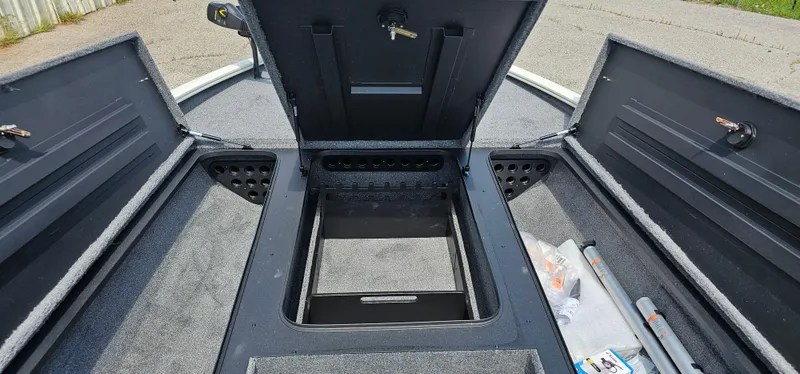 Slide: The Image of Open storage compartments on a 2025 Tracker Savage 215 boat deck. - 6