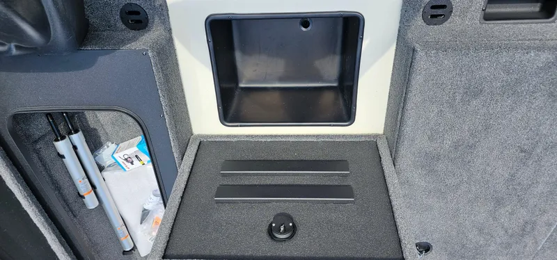 Slide: The Image of Interior storage compartment of 2025 Tracker Savage 215 boat, featuring organized space and accessories. - 8