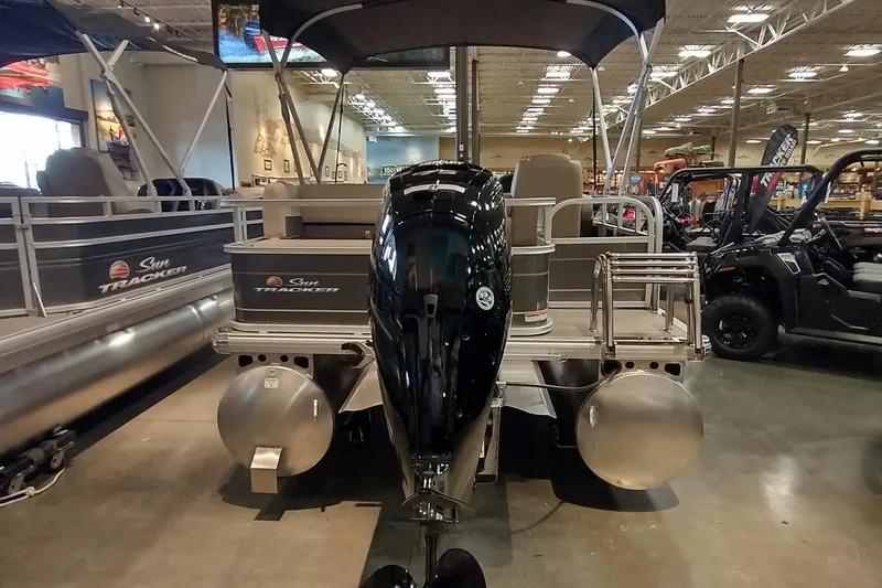 Slide: The Image of 2025 Sun Tracker Party Barge 18 DLX pontoon boat displayed indoors. - 17