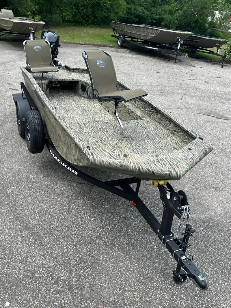 Slide: The Image of 2025 Tracker Grizzly 1650 T Prairie Wings Edition boat on trailer, parked outdoors. - 38