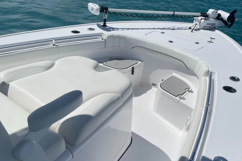Slide: The Image of 2020 Sportsman Masters 267OE Bay Boat interior with seating and storage on calm water. - 3