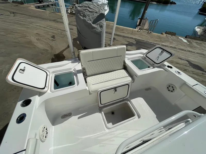 Slide: The Image of 2020 Sportsman Masters 267OE Bay Boat interior with open storage compartments. - 5