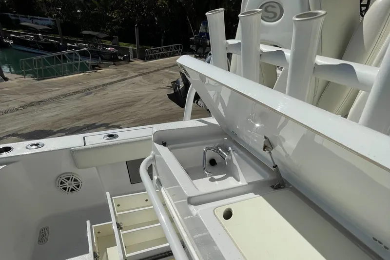 Slide: The Image of 2020 Sportsman Masters 267OE Bay Boat interior with storage compartments and rod holders. - 7