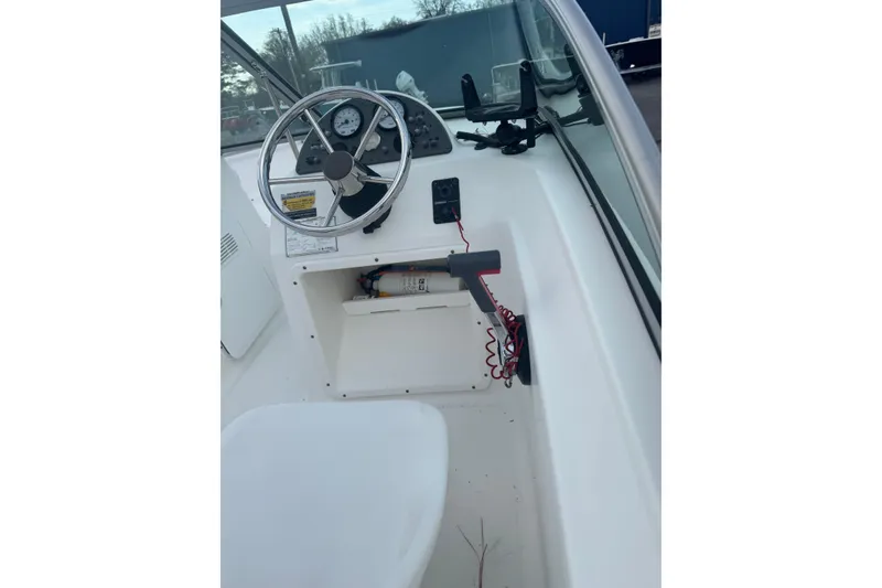 Slide: The Image of 2009 Pioneer 175 Venture boat cockpit with steering wheel and control panel. - 12