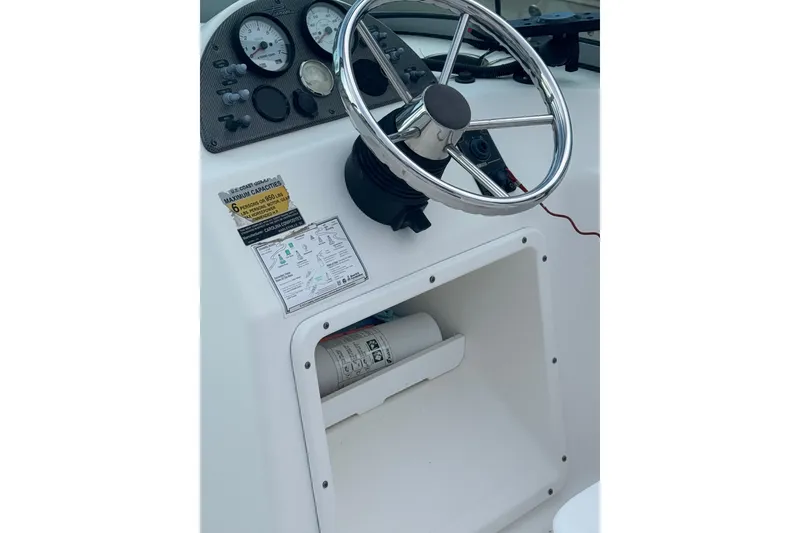 Slide: The Image of 2009 Pioneer 175 Venture boat dashboard with steering wheel and gauges. - 15